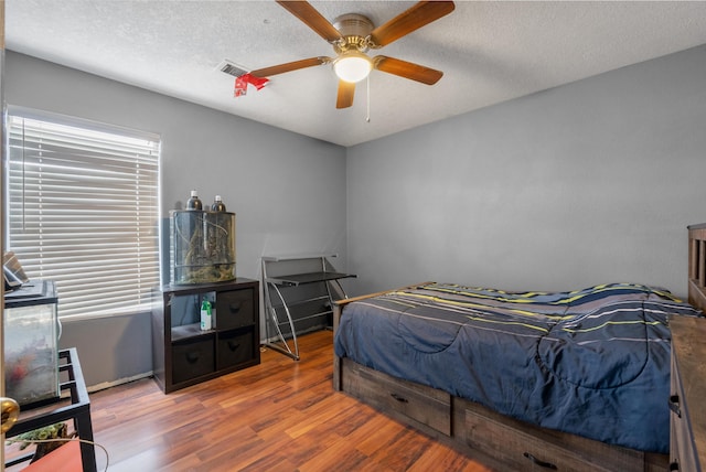 6308 Turquoise Trl NE, Rio Rancho, NM 87144 - bedroom with wood finished floors, ceiling fan, and a textured ceiling