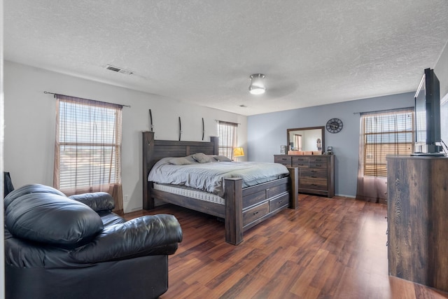 6308 Turquoise Trl NE, Rio Rancho, NM 87144 - bedroom with a textured ceiling, dark wood finished floors, and a ceiling fan