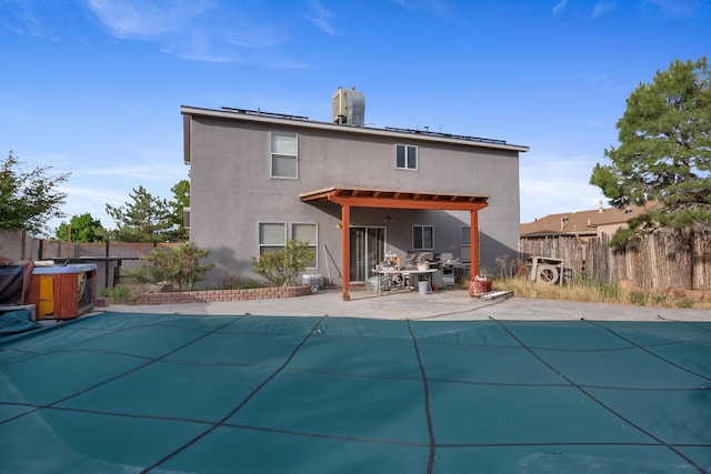 6308 Turquoise Trl NE, Rio Rancho, NM 87144 - rear view of house featuring a fenced backyard, roof mounted solar panels, a patio area, and stucco siding