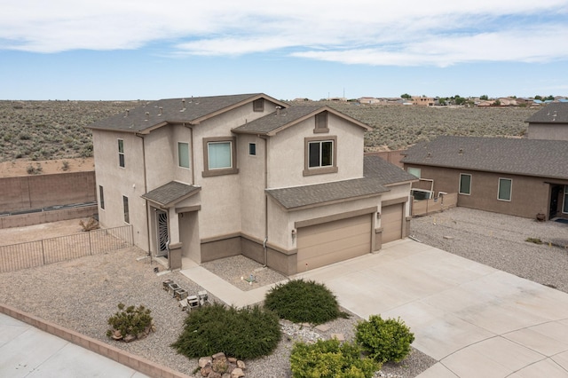 221 Landing Trl, Rio Rancho, NM 87124 - view of front of home with stucco siding, driveway, an attached garage, and a shingled roof