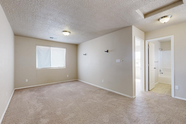 221 Landing Trl, Rio Rancho, NM 87124 - empty room featuring light colored carpet, baseboards, and a textured ceiling