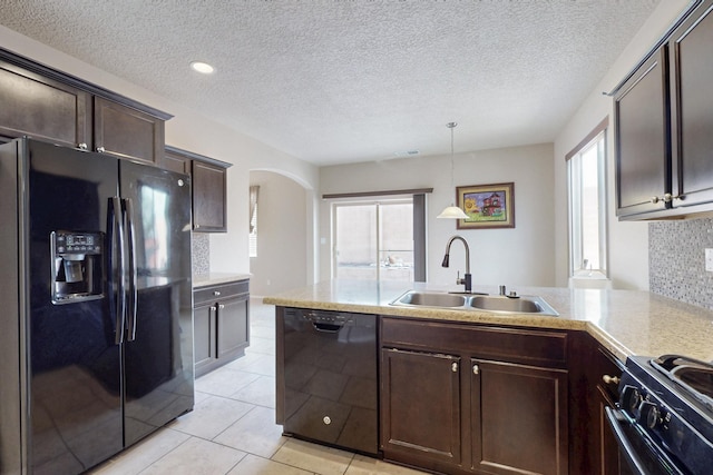 221 Landing Trl, Rio Rancho, NM 87124 - kitchen featuring black appliances, a sink, dark brown cabinets, light countertops, and arched walkways