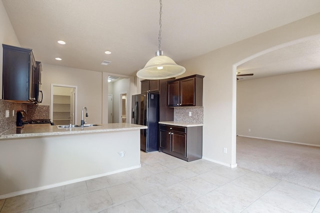 221 Landing Trl, Rio Rancho, NM 87124 - kitchen with a sink, black fridge with ice dispenser, backsplash, range with gas cooktop, and light tile patterned floors