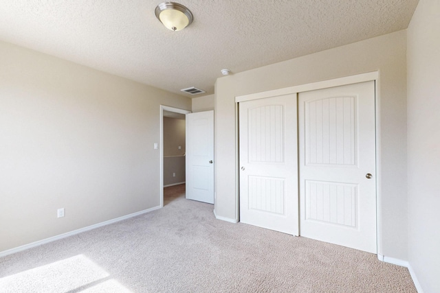 221 Landing Trl, Rio Rancho, NM 87124 - unfurnished bedroom featuring carpet flooring, baseboards, a closet, and a textured ceiling