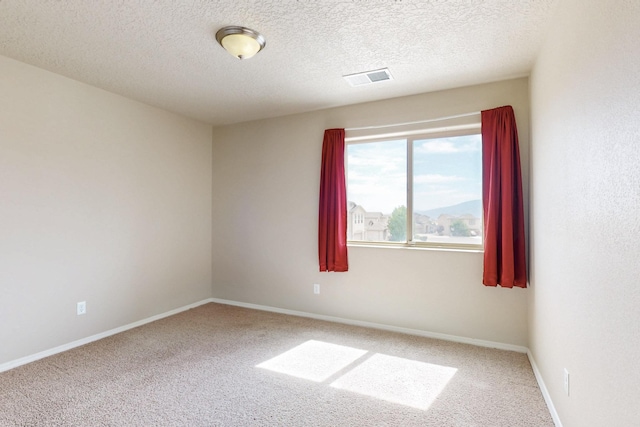 221 Landing Trl, Rio Rancho, NM 87124 - carpeted spare room with baseboards and a textured ceiling