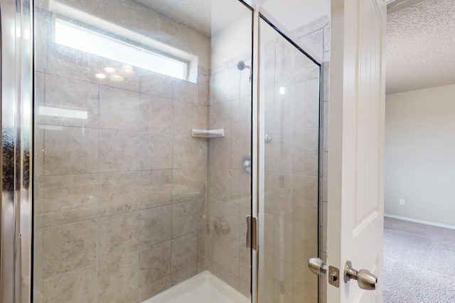221 Landing Trl, Rio Rancho, NM 87124 - bathroom with a stall shower, a textured ceiling, and baseboards