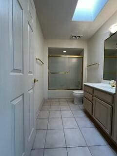 620 Renaissance Loop SE, Rio Rancho, NM 87124 - bathroom with vanity, enclosed tub / shower combo, toilet, a skylight, and tile patterned floors