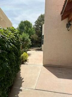 620 Renaissance Loop SE, Rio Rancho, NM 87124 - view of side of property featuring stucco siding and a patio area