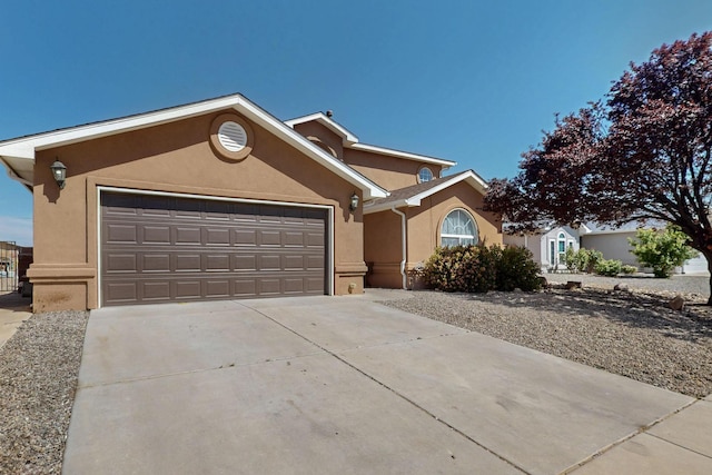 1034 Wagon Trail St, Los Lunas, NM 87031 - single story home featuring stucco siding, concrete driveway, and an attached garage