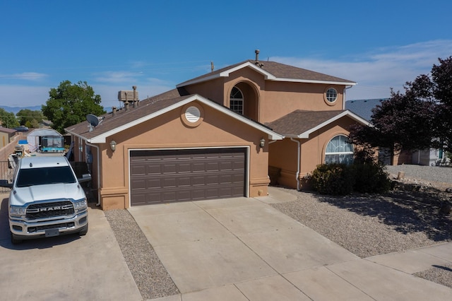 1034 Wagon Trail St, Los Lunas, NM 87031 - view of front of house with stucco siding, concrete driveway, and an attached garage