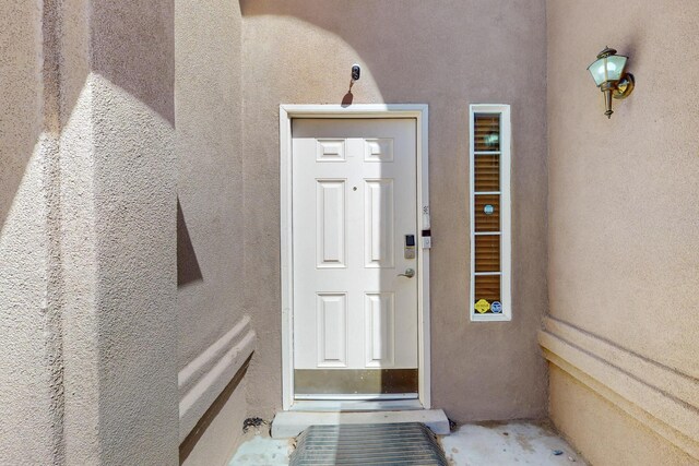 1034 Wagon Trail St, Los Lunas, NM 87031 - doorway to property with stucco siding