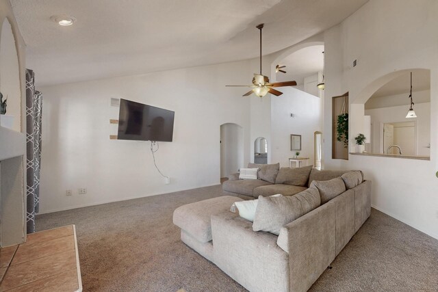1034 Wagon Trail St, Los Lunas, NM 87031 - carpeted living area featuring arched walkways, a ceiling fan, and high vaulted ceiling