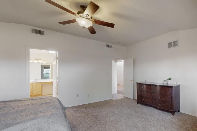 1034 Wagon Trail St, Los Lunas, NM 87031 - unfurnished bedroom with light colored carpet, vaulted ceiling, ensuite bath, and a ceiling fan