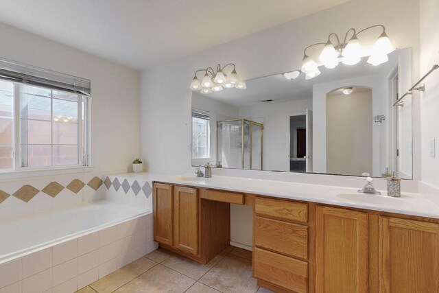 1034 Wagon Trail St, Los Lunas, NM 87031 - bathroom featuring double vanity, tile patterned floors, plenty of natural light, and a shower stall