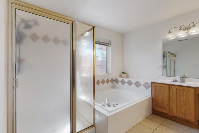 1034 Wagon Trail St, Los Lunas, NM 87031 - full bath featuring vanity, a bath, a shower stall, and tile patterned floors