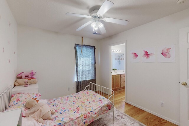 1034 Wagon Trail St, Los Lunas, NM 87031 - bedroom featuring light wood-style flooring, connected bathroom, and a ceiling fan