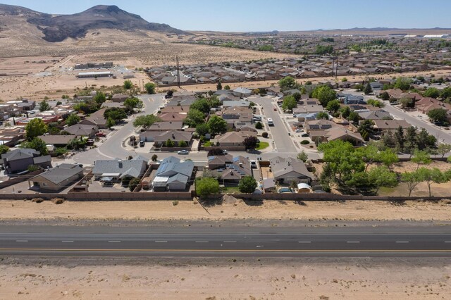 1034 Wagon Trail St, Los Lunas, NM 87031 - aerial view of property and surrounding area with nearby suburban area and a mountainous background