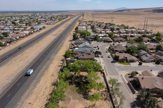 1034 Wagon Trail St, Los Lunas, NM 87031 - aerial view of residential area with a highway and a mountainous background