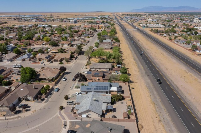 1034 Wagon Trail St, Los Lunas, NM 87031 - aerial overview of property's location featuring mountains and nearby suburban area