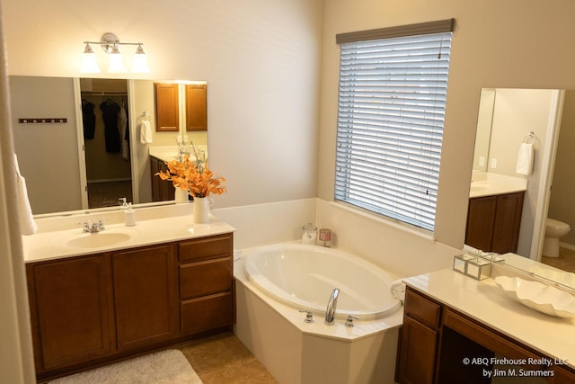 8704 Espacio Verde Rd, Albuquerque, NM 87120 - full bath with vanity, a garden tub, and toilet