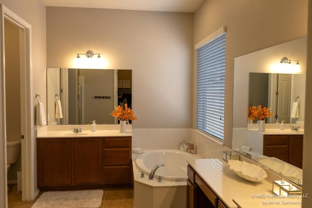 8704 Espacio Verde Rd, Albuquerque, NM 87120 - bathroom with a bath, two vanities, toilet, and tile patterned flooring