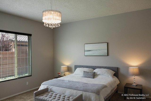 8704 Espacio Verde Rd, Albuquerque, NM 87120 - bedroom with carpet flooring, a chandelier, baseboards, and a textured ceiling