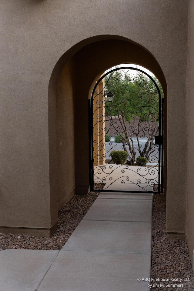 8704 Espacio Verde Rd, Albuquerque, NM 87120 - view of exterior entry with stucco siding and a gate