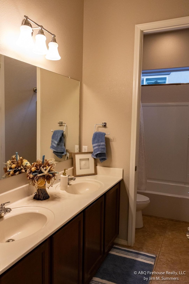 8704 Espacio Verde Rd, Albuquerque, NM 87120 - bathroom featuring double vanity, toilet, tile patterned flooring, and bathtub / shower combination