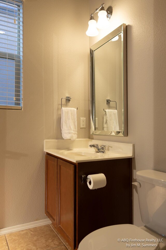8704 Espacio Verde Rd, Albuquerque, NM 87120 - bathroom with toilet, vanity, baseboards, and tile patterned floors