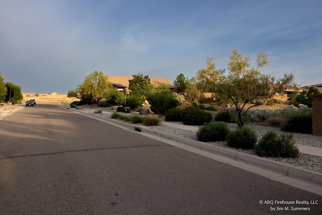 8704 Espacio Verde Rd, Albuquerque, NM 87120 - view of asphalt street with curbs and sidewalks