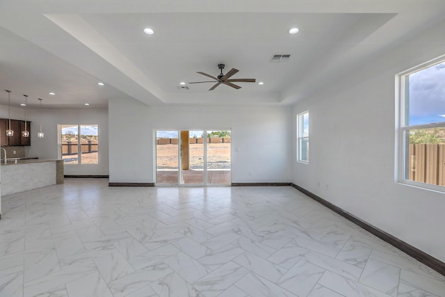 1209 11th St SE, Rio Rancho, NM 87124 - spare room featuring a raised ceiling, healthy amount of natural light, baseboards, recessed lighting, and ceiling fan