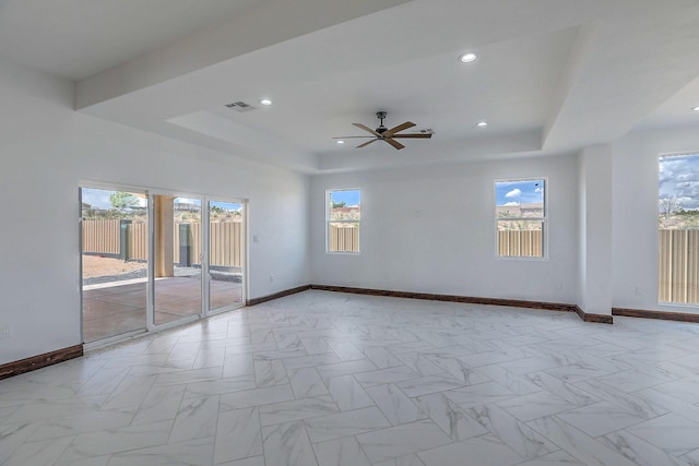 1209 11th St SE, Rio Rancho, NM 87124 - empty room featuring a raised ceiling, baseboards, healthy amount of natural light, a ceiling fan, and recessed lighting