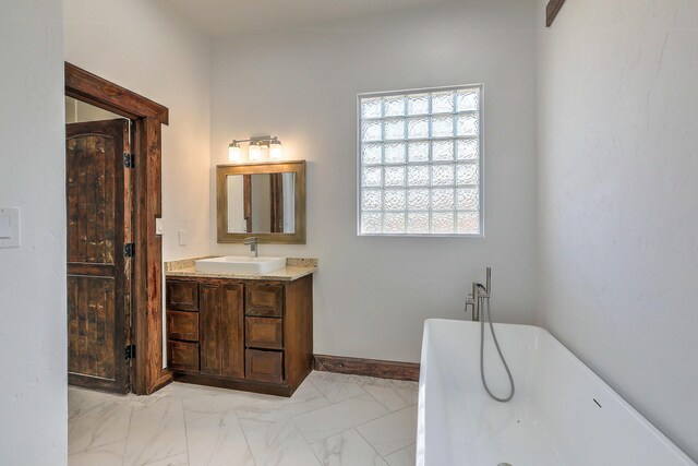 1209 11th St SE, Rio Rancho, NM 87124 - full bath featuring a soaking tub, vanity, marble finish flooring, and baseboards