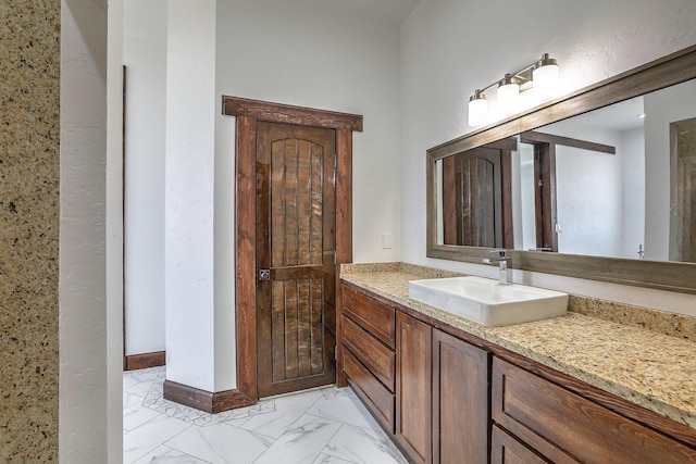 1209 11th St SE, Rio Rancho, NM 87124 - bathroom featuring vanity, marble finish floors, and baseboards