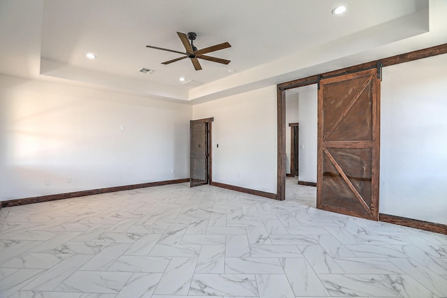 1209 11th St SE, Rio Rancho, NM 87124 - unfurnished bedroom with a raised ceiling, a barn door, baseboards, recessed lighting, and a ceiling fan