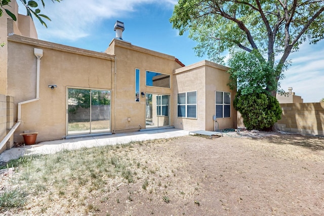 10809 Academy Ridge Rd NE, Albuquerque, NM 87111 - rear view of house with stucco siding and a patio