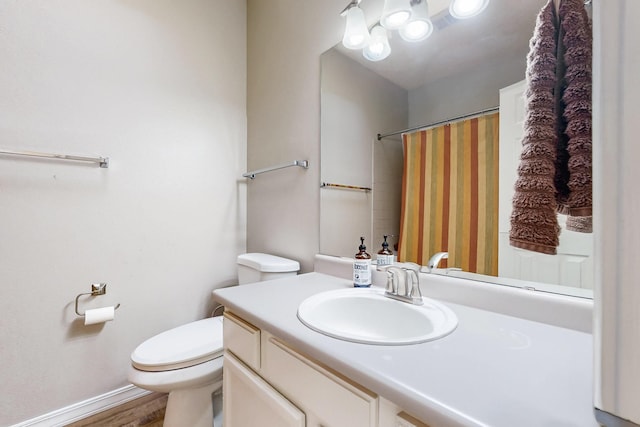 10809 Academy Ridge Rd NE, Albuquerque, NM 87111 - full bathroom featuring toilet, vanity, a shower with shower curtain, and wood finished floors