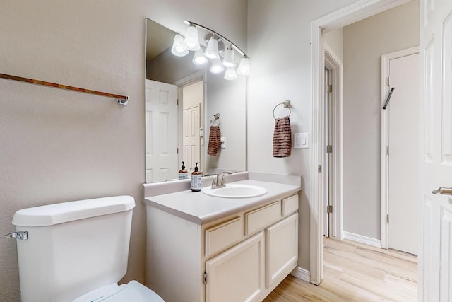 10809 Academy Ridge Rd NE, Albuquerque, NM 87111 - half bath with toilet, vanity, and wood finished floors