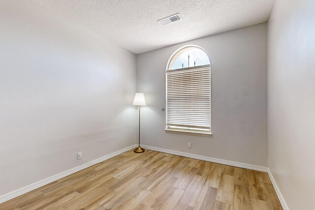 10809 Academy Ridge Rd NE, Albuquerque, NM 87111 - unfurnished room featuring light wood finished floors, baseboards, and a textured ceiling