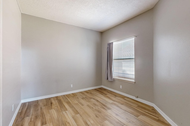 10809 Academy Ridge Rd NE, Albuquerque, NM 87111 - empty room featuring light wood-style floors, baseboards, and a textured ceiling