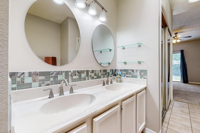 10809 Academy Ridge Rd NE, Albuquerque, NM 87111 - bathroom featuring tile patterned flooring, double vanity, ceiling fan, and backsplash