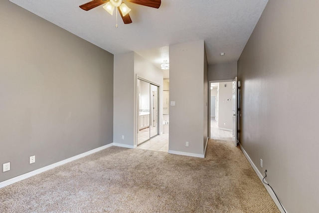 10809 Academy Ridge Rd NE, Albuquerque, NM 87111 - unfurnished bedroom featuring light carpet, connected bathroom, and baseboards