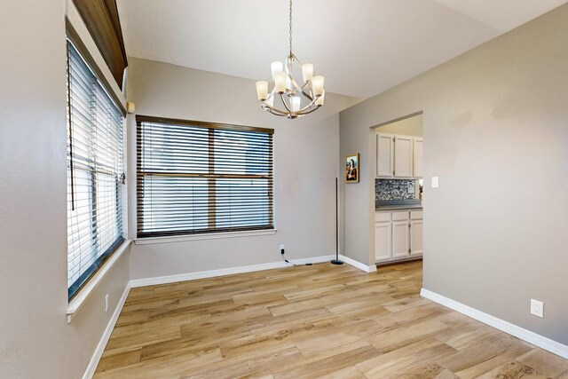 10809 Academy Ridge Rd NE, Albuquerque, NM 87111 - empty room with a chandelier, healthy amount of natural light, and light wood-style floors
