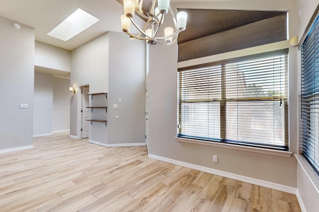 10809 Academy Ridge Rd NE, Albuquerque, NM 87111 - spare room featuring a skylight, healthy amount of natural light, and wood finished floors