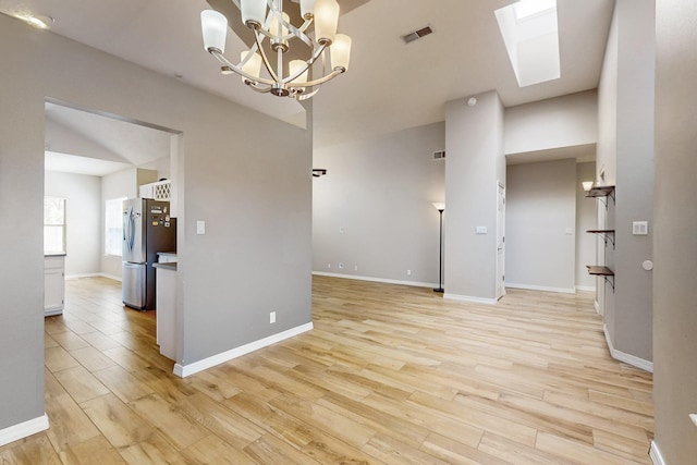 10809 Academy Ridge Rd NE, Albuquerque, NM 87111 - spare room with light wood-type flooring, a chandelier, and baseboards