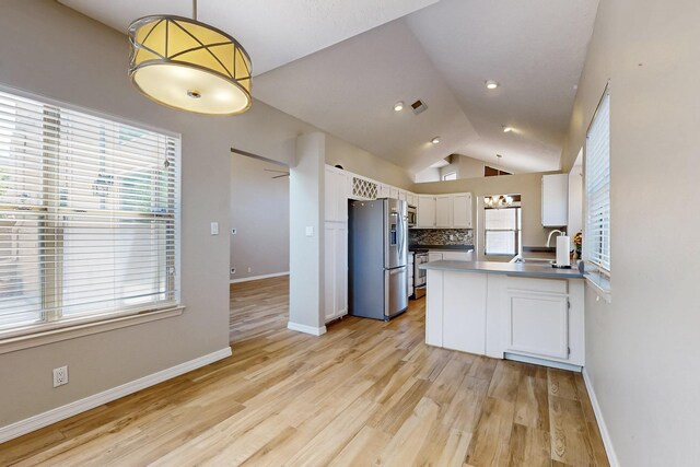 10809 Academy Ridge Rd NE, Albuquerque, NM 87111 - kitchen featuring appliances with stainless steel finishes, white cabinets, plenty of natural light, and vaulted ceiling