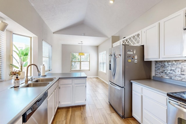10809 Academy Ridge Rd NE, Albuquerque, NM 87111 - kitchen featuring appliances with stainless steel finishes, a sink, lofted ceiling, white cabinets, and light wood-style floors
