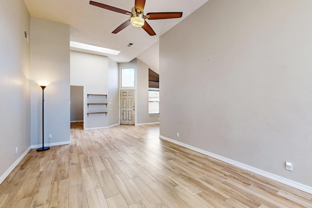10809 Academy Ridge Rd NE, Albuquerque, NM 87111 - unfurnished living room featuring a ceiling fan, high vaulted ceiling, light wood-style floors, and baseboards