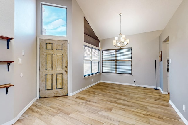 10809 Academy Ridge Rd NE, Albuquerque, NM 87111 - entrance foyer with a chandelier, light wood-style floors, lofted ceiling, and baseboards