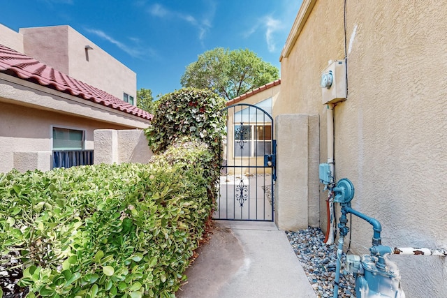 10809 Academy Ridge Rd NE, Albuquerque, NM 87111 - entrance to property with a gate, stucco siding, and a tile roof